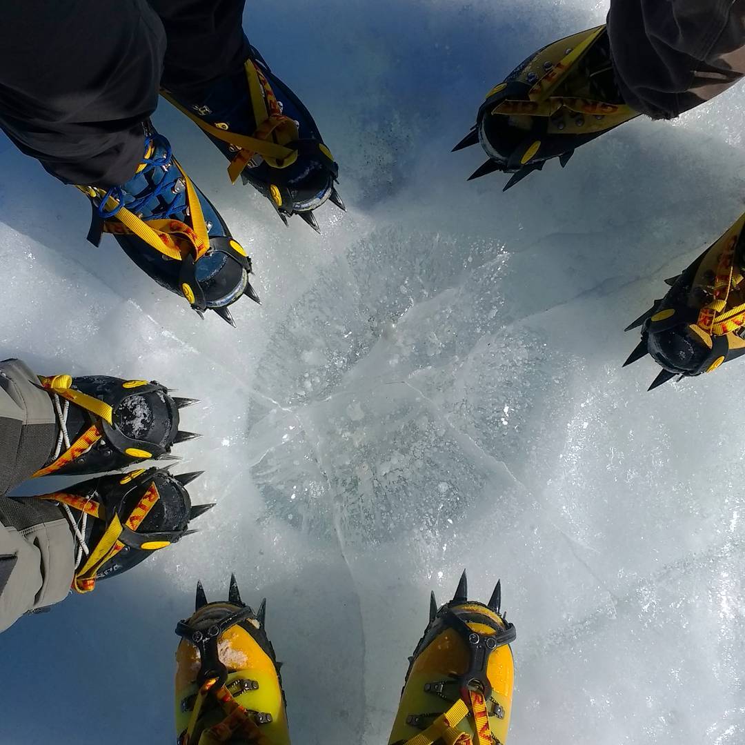 Field boots at a cryoconite hole on Antarctic glacier ice.